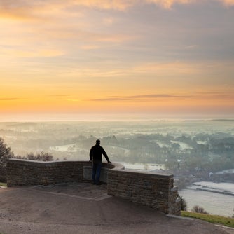 Visitor at the view point looking across towards the South Downs on a frosty winter's morning